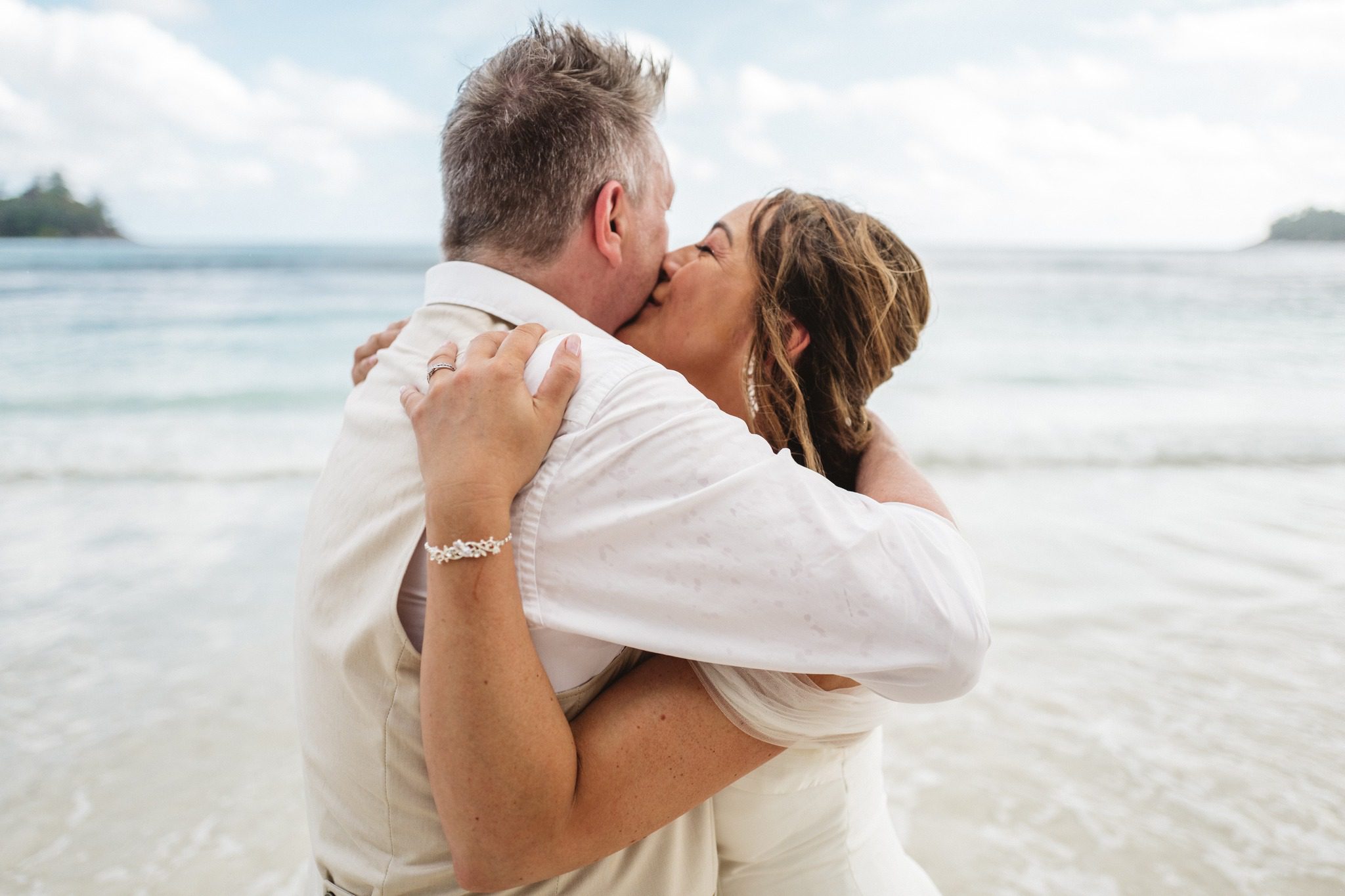 Newlyweds at sunset after their Seychelles beach wedding