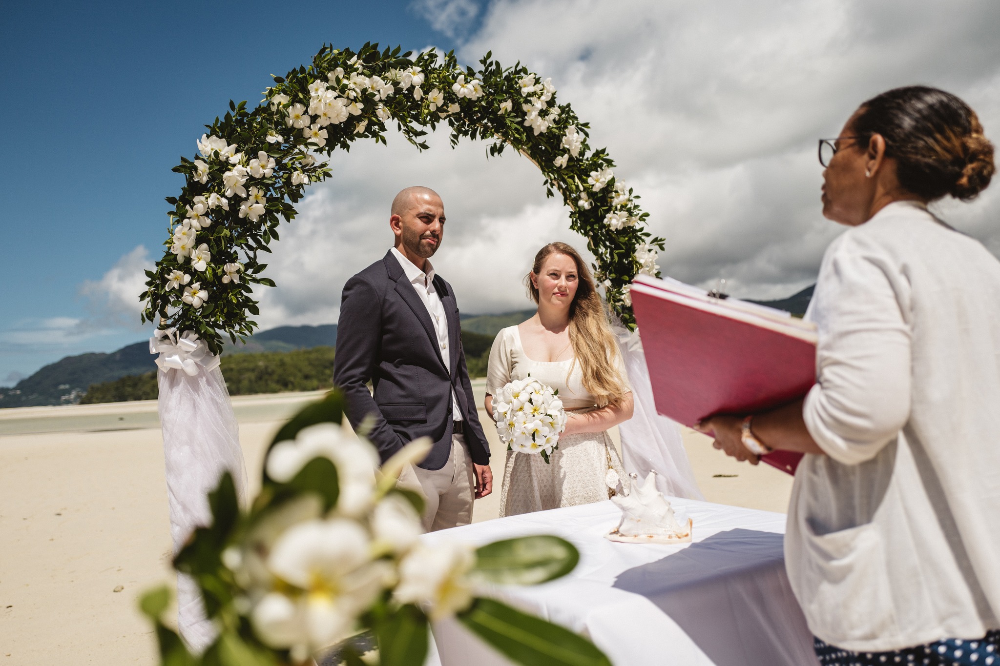Couple signing their official marriage documents at a beach wedding in Seychelles